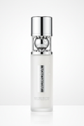 Hair care lotion bottle with massage ball roller on white studio background
